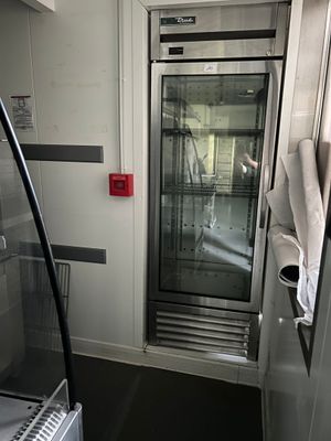a glass door in the middle of a bathroom