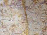 a close up view of a marble slab with yellow streaks on it