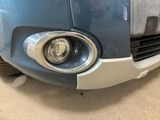 the front end of a blue car with a white stripe on it