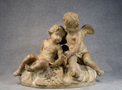 a statue of a boy and a girl sitting on a rock