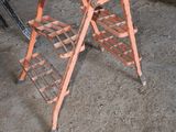 a wooden table with a ladder on it in the middle of a room