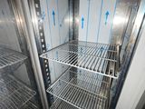 an open refrigerator with a lot of shelves in it