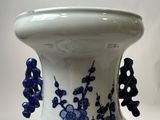 a blue and white vase sitting on a table