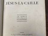 a book open on a table with a picture of jesus - la - calle on it