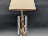 an image of a table lamp with a gold rose on it