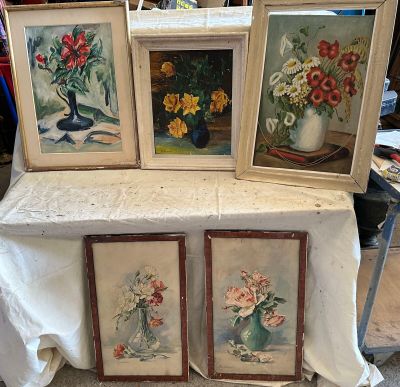 trois tableaux encadrés représentant des fleurs posées sur une table recouverte d'une nappe blanche