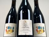three bottles of wine sitting next to each other on a table