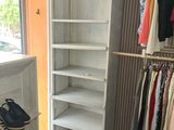 an image of a closet with clothes on hangers