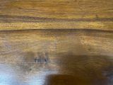 a close up of a wooden table with a shadow on it