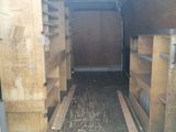 the back of a moving truck with wooden crates in the back of it
