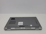 the back of a silver laptop computer sitting on top of a white table