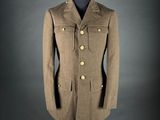 a brown coat on a mannequin stand against a gray background