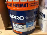 a close up of a bucket of paint sitting on a pallet