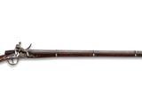 un vieux pistolet avec un canon en bois et une poignée en métal