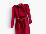 an image of a red coat hanging on a wall