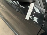 a sticker on the door of a car that has a parking meter attached to it