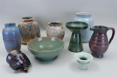 many different types of vases and bowls on the table