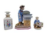 a figurine of a woman washing dishes with a child