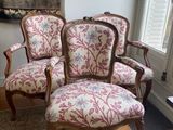 three chairs in a room with a rug on the floor