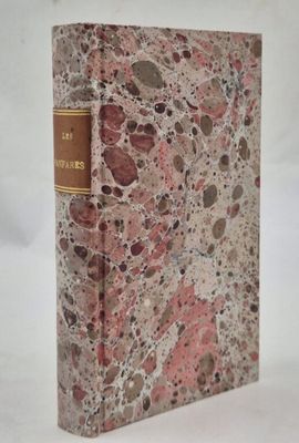 an old book sitting on top of a table covered in marble