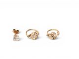 three pairs of gold earrings and a ring on a white background