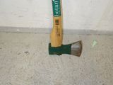 a hammer that is laying on the floor next to a wall