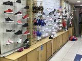 many pairs of shoes on display in a shoe store