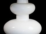 a white table lamp with a yellow shade on it