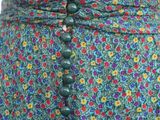 a close up of a woman ' s skirt with buttons on it