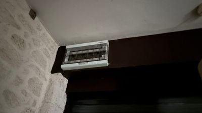a small air conditioner on the wall of a room