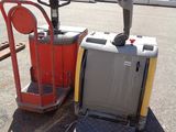 a fork lifter and a pallet in a parking lot