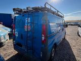 a blue van parked in a parking lot with other cars