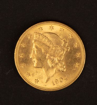 Gros plan sur une pièce d'or ornée d'une tête de femme
