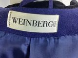 a close up of a label on a blue jacket on a mannequin