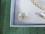 a box with a necklace, earrings, and a pair of scissors