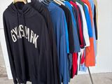 a rack with a bunch of shirts hanging on it