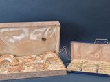 two pieces of jewelry in a case on a table