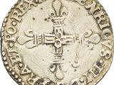 an old silver coin with a cross on it on a white background