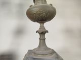 a statue of a woman on top of a vase on a pedestal