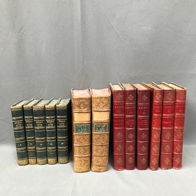 several old books are lined up in a row on a table