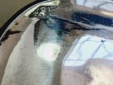 reflection of a car in a mirror on the side of the road
