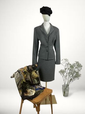 a mannequin sitting next to a chair in a room