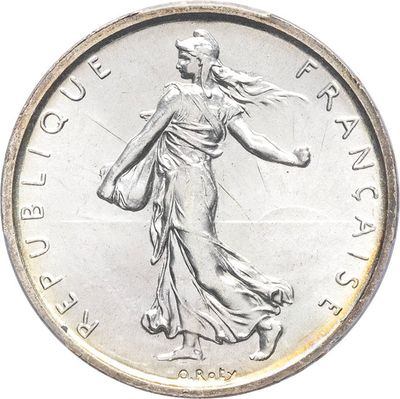 an image of a silver coin with a woman walking on it