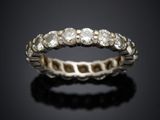 a close up of a diamond ring on a black surface