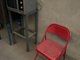 two chairs and a microwave in a small room