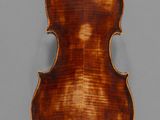 an old violin with a wooden back and a long neck