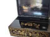 a black and gold box with a mirror in it