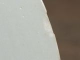 a close up of a white plate on a table