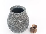 a small vase and a small vase on a white surface
