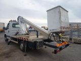 a white truck with a crane on the back of it